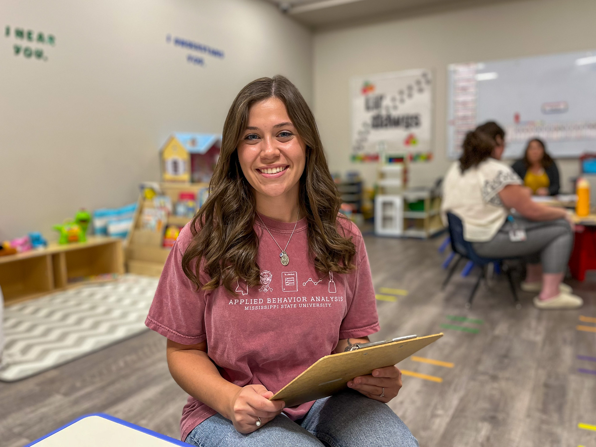 MSU student sitting with a clipboard in a classroom