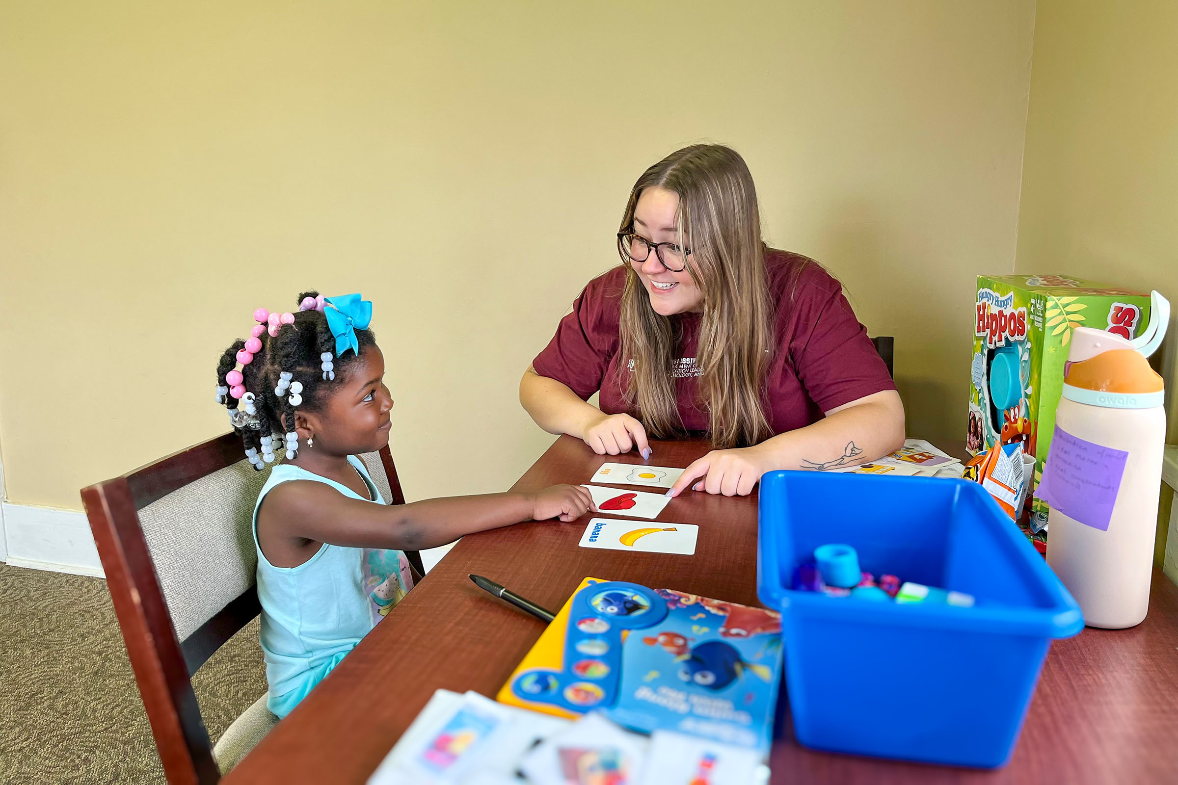 MSU student works with a child at a clinic