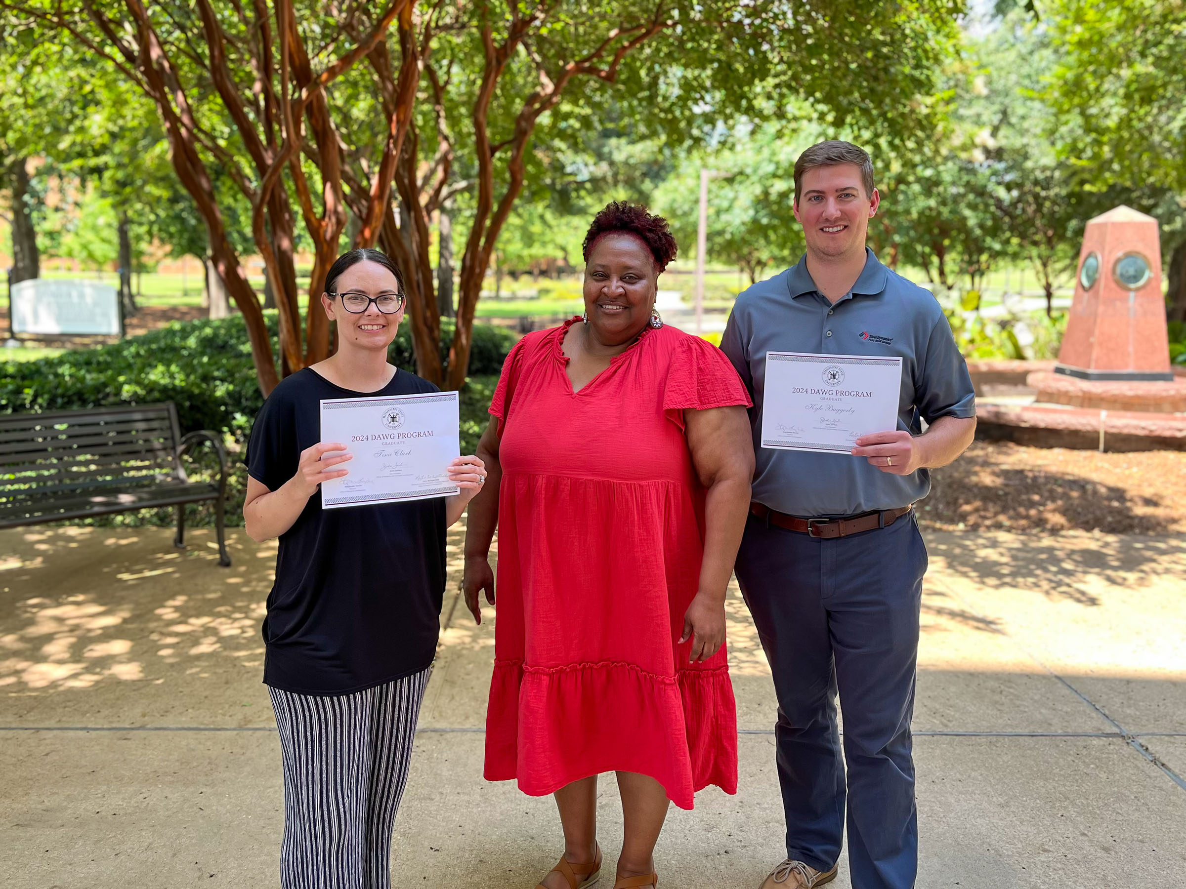 Three College of Education staff members pose for photo