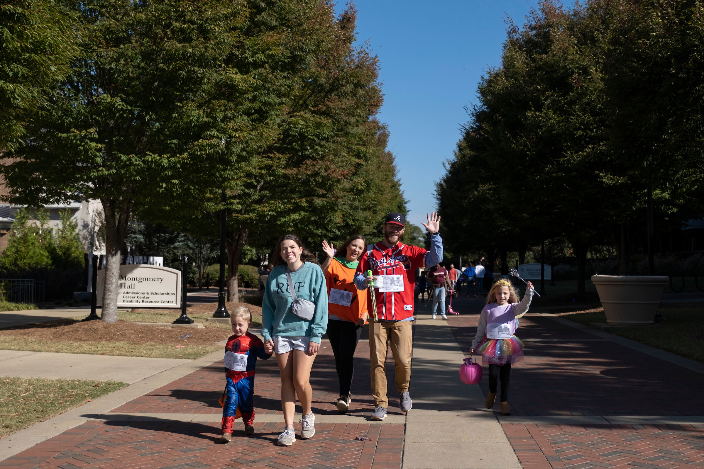 Families participating in a fun run on campus