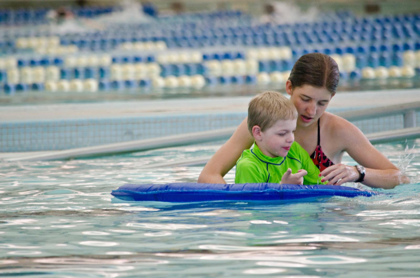 Photo of camper being assisted in the pool