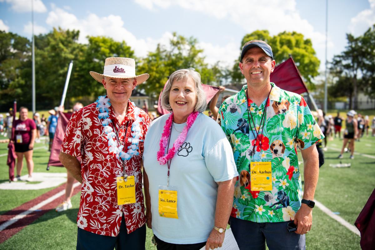 Leaders of the Famous Maroon Band pose for a photo on the practice field