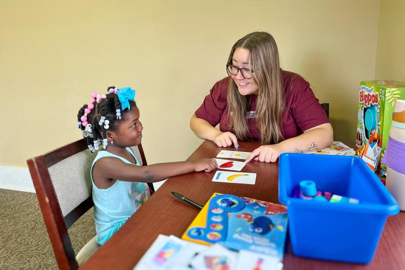 MSU student working with a child in a clinic