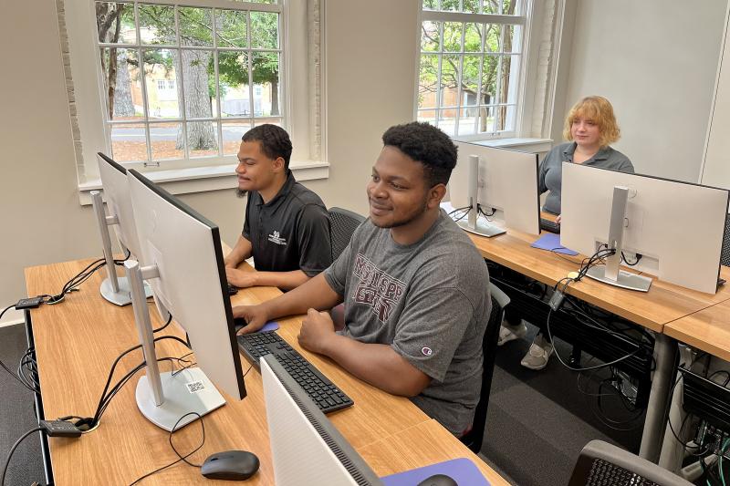 Three MSU students working in a computer lab